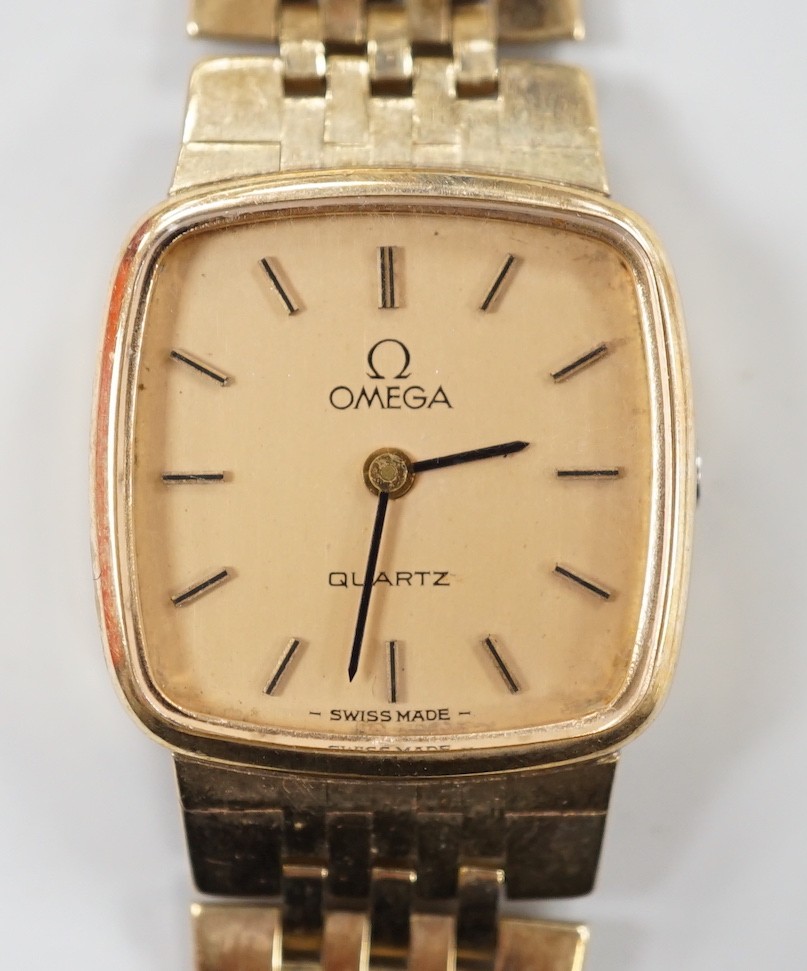 A lady's 9ct gold Omega quartz wrist watch, on a 9ct gold Omega bracelet, overall 17.3cm, gross weight 29 grams, with Omega box and booklet.